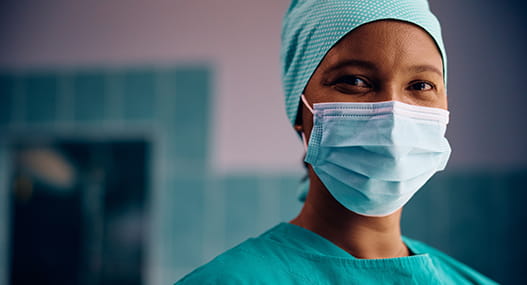 doctor surgeon with mask looking into camera